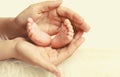 Mother holding in her hands baby feet close up Royalty Free Stock Photo