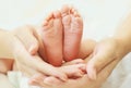 Mother holding in her hands baby feet close up Royalty Free Stock Photo