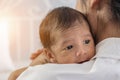 Mother holding her infant baby boy on her shoulder Royalty Free Stock Photo