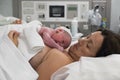 mother holding her newborn baby on her chest just after birth Royalty Free Stock Photo