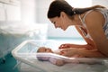 Mother holding her newborn baby child after labor in a hospital Royalty Free Stock Photo