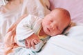 Mother holding her newborn baby child after labor in a hospital. Royalty Free Stock Photo