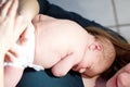 Mother holding her newborn baby daughter after birth on arms. Royalty Free Stock Photo