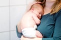 Mother holding her newborn baby daughter after birth on arms. Royalty Free Stock Photo