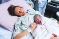 Mother holding her newborn baby after labor in a hospital. Royalty Free Stock Photo
