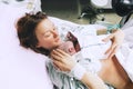 Mother holding her newborn baby after labor in a hospital. Royalty Free Stock Photo