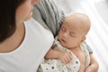 Mother holding her sleeping baby indoors, above view Royalty Free Stock Photo