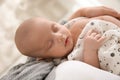 Mother holding her sleeping baby indoors, closeup Royalty Free Stock Photo