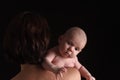 A mother holding her son on black background Royalty Free Stock Photo