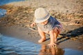Mother holding her son with a summer hat on the beach Royalty Free Stock Photo