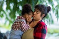 Mother holding his Daughter in her arms looking at her with love in vegetable garden. Happy loving mother holding daughter and lau Royalty Free Stock Photo