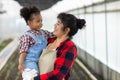 Mother holding his Daughter in her arms looking at her with love in vegetable garden. Happy loving mother holding daughter and lau Royalty Free Stock Photo