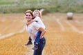 Mother holding kid boy on arms on wheat field in summer Royalty Free Stock Photo