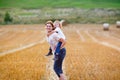 Mother holding kid boy on arms on wheat field in summer Royalty Free Stock Photo