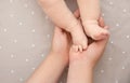 Mother holding baby feet in hands, top view Royalty Free Stock Photo