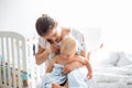 Mother holding little baby wrapped in towel after bath, cleaning Royalty Free Stock Photo