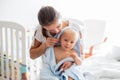 Mother holding little baby wrapped in towel after bath, cleaning Royalty Free Stock Photo