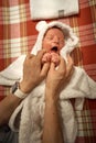 Mother holding little baby wrapped in towel after bath Royalty Free Stock Photo