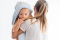 Mother holding little baby wrapped in towel after bath Royalty Free Stock Photo