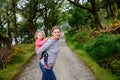 Mother holding little toddler girl in Glenveagh national park in Ireland. Smiling and laughing baby child and woman