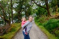Mother holding little toddler girl in Glenveagh national park in Ireland. Smiling and laughing baby child and woman