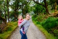 Mother holding little toddler girl in Glenveagh national park in Ireland. Smiling and laughing baby child and woman