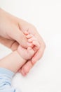 Mother holding newborn baby child little hand with small fingers Royalty Free Stock Photo