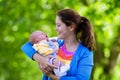 Mother holding newborn baby in a park Royalty Free Stock Photo