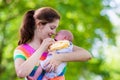 Mother holding newborn baby in a park Royalty Free Stock Photo