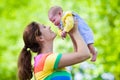 Mother holding newborn baby in a park Royalty Free Stock Photo