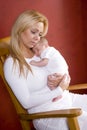 Mother holding newborn baby in rocking chair Royalty Free Stock Photo