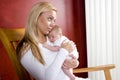 Mother holding newborn baby in rocking chair Royalty Free Stock Photo