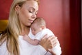 Mother holding newborn baby in rocking chair Royalty Free Stock Photo