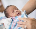 Mother holding newborn infant in hospital