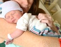 Mother holding newborn infant in hospital