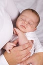 Mother holding sleeping baby boy in her arms Royalty Free Stock Photo