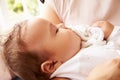 Mother Holding Sleeping Baby Boy At Home Royalty Free Stock Photo