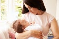 Mother Holding Sleeping Baby Boy At Home Royalty Free Stock Photo