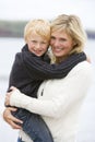 Mother holding son at beach smiling Royalty Free Stock Photo