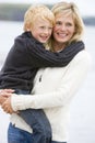 Mother holding son at beach smiling Royalty Free Stock Photo