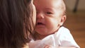 Mother holding and soothing crying baby girl