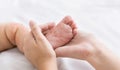 Mother holding tiny baby foot with measles rash Royalty Free Stock Photo