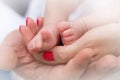 Mother holding tiny foot of newborn baby, close-up Royalty Free Stock Photo