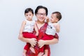 Mother holding two baby Boys. Great happiness, happy young mom with two twins baby. Portrait of young mother holding her little tw Royalty Free Stock Photo