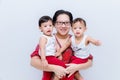 Mother holding two baby Boys. Great happiness, happy young mom with two twins baby. Portrait of young mother holding her little tw Royalty Free Stock Photo