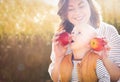 Mother holding two red ripe apples. Child (baby boy, kid) eating healthy food, snack in autumn day. Royalty Free Stock Photo