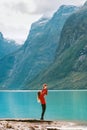 Mother holding up baby traveling together enjoying Lovatnet lake Royalty Free Stock Photo