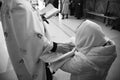 Mother holds baby in church at sacrament of baptism.