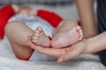 Mother holds baby feet in hands Royalty Free Stock Photo