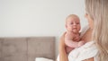 Mother holds baby in arms after feeding for burping. motherhood, newborn care